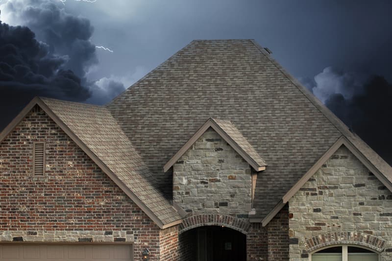 A brick house under dark storm clouds